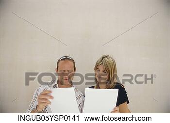 Stock Photography - young couple reading 
documents together. 
fotosearch - search 
stock photos, 
pictures, images, 
and photo clipart