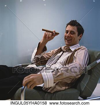 Stock Photo - portrait of a 
young man holding 
a cigar. fotosearch 
- search stock 
photos, pictures, 
images, and photo 
clipart
