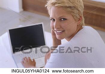 Stock Photo - portrait of a 
young woman working 
on a laptop. fotosearch 
- search stock 
photos, pictures, 
images, and photo 
clipart