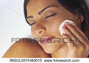 Stock Photography - young woman wiping 
her face with 
a cotton wool 
pad. fotosearch 
- search stock 
photos, pictures, 
images, and photo 
clipart