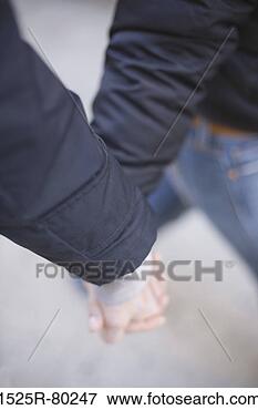 Close-up of two people holding hands and walking View Large Photo Image Picture - close-up of two people holding hands and walking. fotosearch - search stock photos, pictures, images, and photo clipart