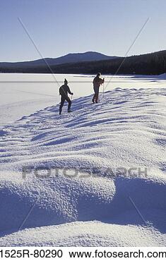 Stock Photography - two hikers on 
a snow covered 
landscape. fotosearch 
- search stock 
photos, pictures, 
images, and photo 
clipart