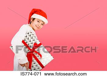 Stock Photography - boy wearing santa 
hat and holding 
present. fotosearch 
- search stock 
photos, pictures, 
images, and photo 
clipart