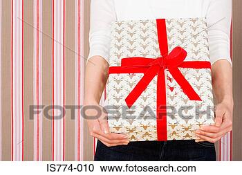 Stock Photography - woman holding 
present. fotosearch 
- search stock 
photos, pictures, 
images, and photo 
clipart