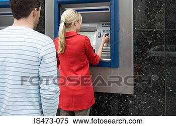 Stock Image - woman using cash 
machine. fotosearch 
- search stock 
photos, pictures, 
images, and photo 
clipart