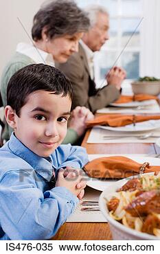 Stock Image - boy and family 
saying grace. 
fotosearch - search 
stock photos, 
pictures, images, 
and photo clipart