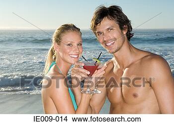 Stock Photo - couple with cocktails 
on the beach. 
fotosearch - search 
stock photos, 
pictures, images, 
and photo clipart