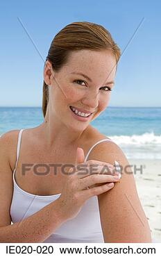 Stock Photography - young woman applying 
suncream. fotosearch 
- search stock 
photos, pictures, 
images, and photo 
clipart