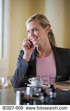 Stock Photograph - woman on cellphone 
with coffee. fotosearch 
- search stock 
photos, pictures, 
images, and photo 
clipart