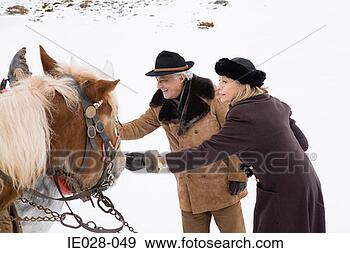 Stock Photograph - couple stroking 
horses. fotosearch 
- search stock 
photos, pictures, 
images, and photo 
clipart