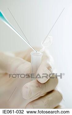 Stock Photo - scientist holding 
a pipette. fotosearch 
- search stock 
photos, pictures, 
images, and photo 
clipart