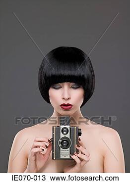 Stock Photo - woman using a 
vintage camera. 
fotosearch - search 
stock photos, 
pictures, images, 
and photo clipart