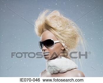 Stock Photo - woman wearing 
sunglasses in 
snow. fotosearch 
- search stock 
photos, pictures, 
images, and photo 
clipart