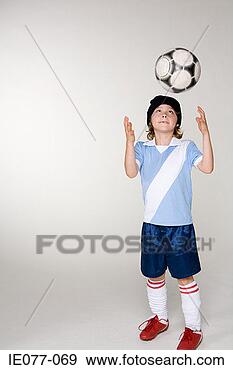 Stock Photograph - a boy throwing 
a football. fotosearch 
- search stock 
photos, pictures, 
images, and photo 
clipart