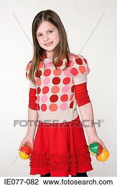 Stock Photo - a girl holding 
balls. fotosearch 
- search stock 
photos, pictures, 
images, and photo 
clipart