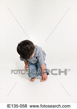 Stock Photo - a boy bending 
over. fotosearch 
- search stock 
photos, pictures, 
images, and photo 
clipart
