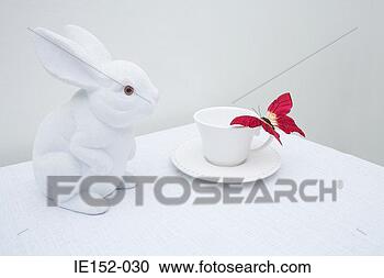 Stock Photography - a toy rabbit and 
a fake butterfly 
on a cup. fotosearch 
- search stock 
photos, pictures, 
images, and photo 
clipart
