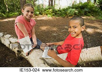 Stock Photo - boy and girl with 
drawings. fotosearch 
- search stock 
photos, pictures, 
images, and photo 
clipart