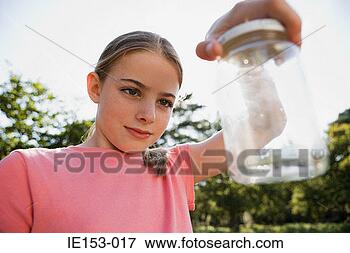Picture - girl looking at 
jar. fotosearch 
- search stock 
photos, pictures, 
images, and photo 
clipart