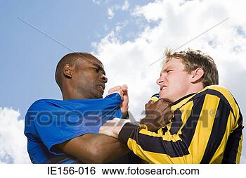 Stock Photo - rival footballers 
fighting. fotosearch 
- search stock 
photos, pictures, 
images, and photo 
clipart