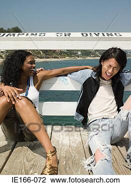 Stock Photo - young couple laughing 
on a pier. fotosearch 
- search stock 
photos, pictures, 
images, and photo 
clipart