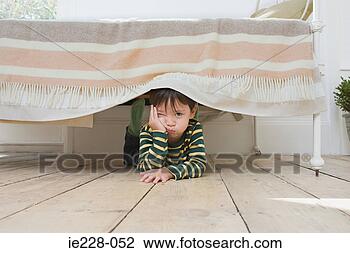 Stock Photo - Boy hiding under a bed. Fotosearch - Search Stock ...