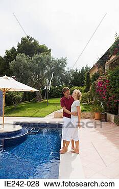 Stock Photo - a couple hugging 
by a swimming 
pool. fotosearch 
- search stock 
photos, pictures, 
images, and photo 
clipart