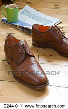 Picture - shoes newspaper 
and cup. fotosearch 
- search stock 
photos, pictures, 
images, and photo 
clipart