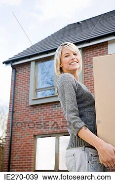 Stock Photograph - young woman moving 
house. fotosearch 
- search stock 
photos, pictures, 
images, and photo 
clipart