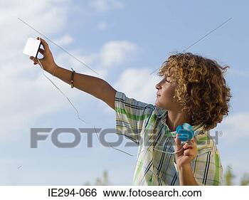 Stock Photo - boy using a small 
solar panel. fotosearch 
- search stock 
photos, pictures, 
images, and photo 
clipart