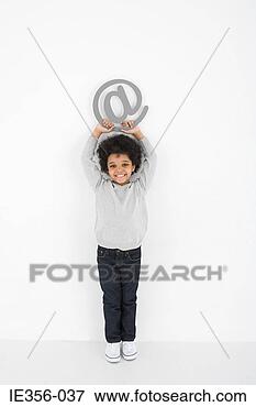 Picture - boy holding an 
at symbol. fotosearch 
- search stock 
photos, pictures, 
images, and photo 
clipart