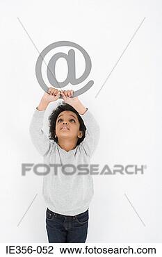 Stock Photo - boy holding an 
at symbol. fotosearch 
- search stock 
photos, pictures, 
images, and photo 
clipart