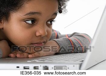 Stock Image - boy leaning on 
laptop. fotosearch 
- search stock 
photos, pictures, 
images, and photo 
clipart