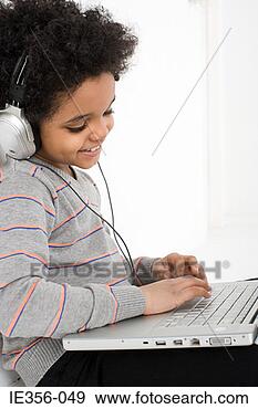 Stock Photograph - boy listening 
to music on laptop. 
fotosearch - search 
stock photos, 
pictures, images, 
and photo clipart