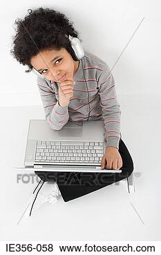 Stock Photo - boy listening 
to music on laptop. 
fotosearch - search 
stock photos, 
pictures, images, 
and photo clipart