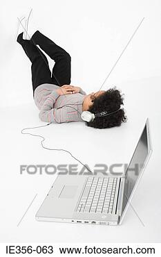 Stock Photo - boy listening 
to music on laptop. 
fotosearch - search 
stock photos, 
pictures, images, 
and photo clipart