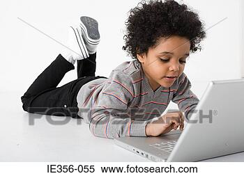 Stock Image - boy using laptop. 
fotosearch - search 
stock photos, 
pictures, images, 
and photo clipart