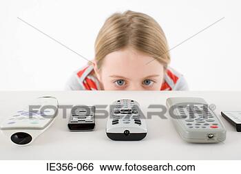 Stock Photo - girl looking at 
remote controls. 
fotosearch - search 
stock photos, 
pictures, images, 
and photo clipart