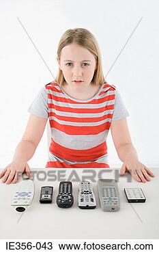 Stock Photo - girl with remote 
controls. fotosearch 
- search stock 
photos, pictures, 
images, and photo 
clipart