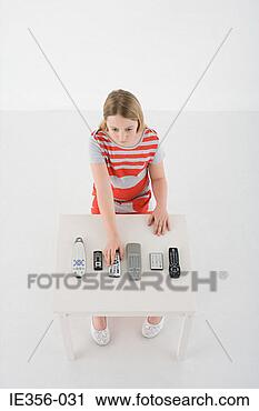 Stock Photography - girl using remote 
control. fotosearch 
- search stock 
photos, pictures, 
images, and photo 
clipart