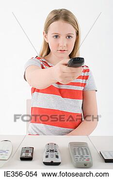 Stock Photo - girl using remote 
control. fotosearch 
- search stock 
photos, pictures, 
images, and photo 
clipart