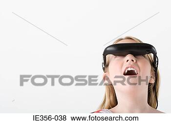 Stock Photo - girl wearing virtual 
reality headset. 
fotosearch - search 
stock photos, 
pictures, images, 
and photo clipart