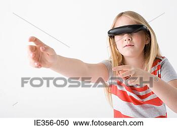 Stock Photography - girl wearing virtual 
reality headset. 
fotosearch - search 
stock photos, 
pictures, images, 
and photo clipart