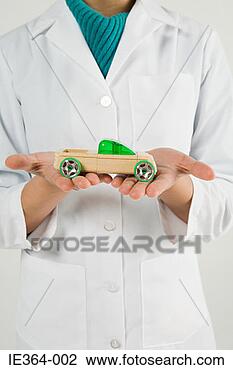 Stock Photo - scientist holding 
toy car. fotosearch 
- search stock 
photos, pictures, 
images, and photo 
clipart