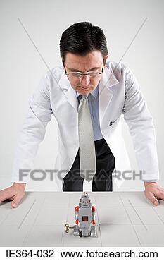 Stock Photo - scientist looking 
at robot. fotosearch 
- search stock 
photos, pictures, 
images, and photo 
clipart