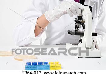 Stock Photo - scientist with 
microscope. fotosearch 
- search stock 
photos, pictures, 
images, and photo 
clipart