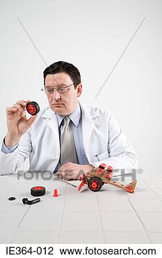 Stock Photo - scientist with 
model helicopter. 
fotosearch - search 
stock photos, 
pictures, images, 
and photo clipart