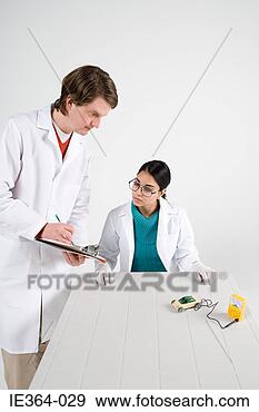 Stock Photograph - scientists with 
model car. fotosearch 
- search stock 
photos, pictures, 
images, and photo 
clipart