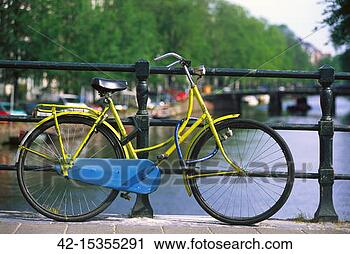Stock Photography - yellow bycicle 
on a bridge, amsterdam, 
netherlands, europe. 
fotosearch - search 
stock photos, 
pictures, images, 
and photo clipart