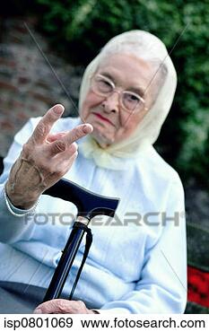 Stock Photograph - a bespectacled 
woman with headscarf 
and walking stick 
showing two. fotosearch 
- search stock 
photos, pictures, 
images, and photo 
clipart
